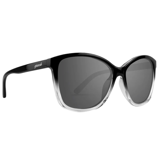 A pair of cat-eye sunglasses with a black and clear gradient frame and dark gray lenses, shown on a white background with black letterbox bars at the top and bottom.