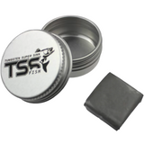 A small tin container with a label that reads 'TSS FISH' next to a piece of black moldable tungsten putty.