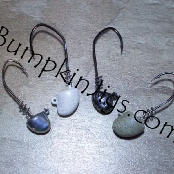 Three fishing hooks with varying designs, labeled with 'BumpkinJigs.com' on a dark background.
